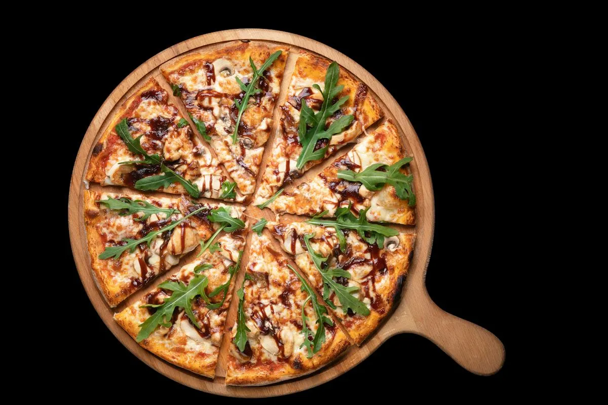 Vegetable-topped gourmet pizza on a round serving board